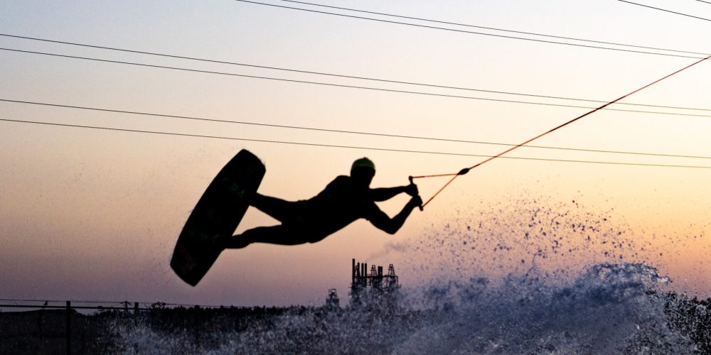 wakeboard. wakeboarding jumping at sunset