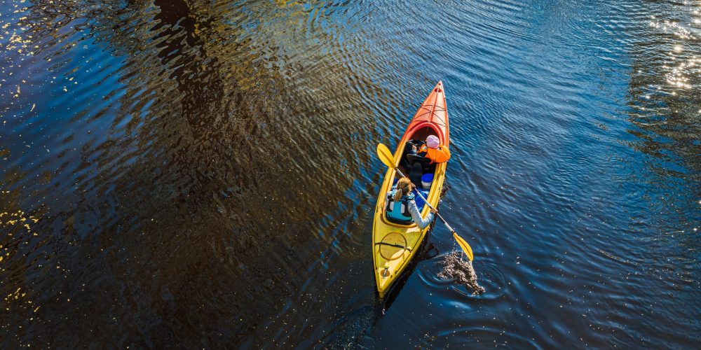 A woman canoeing on the water during daytime